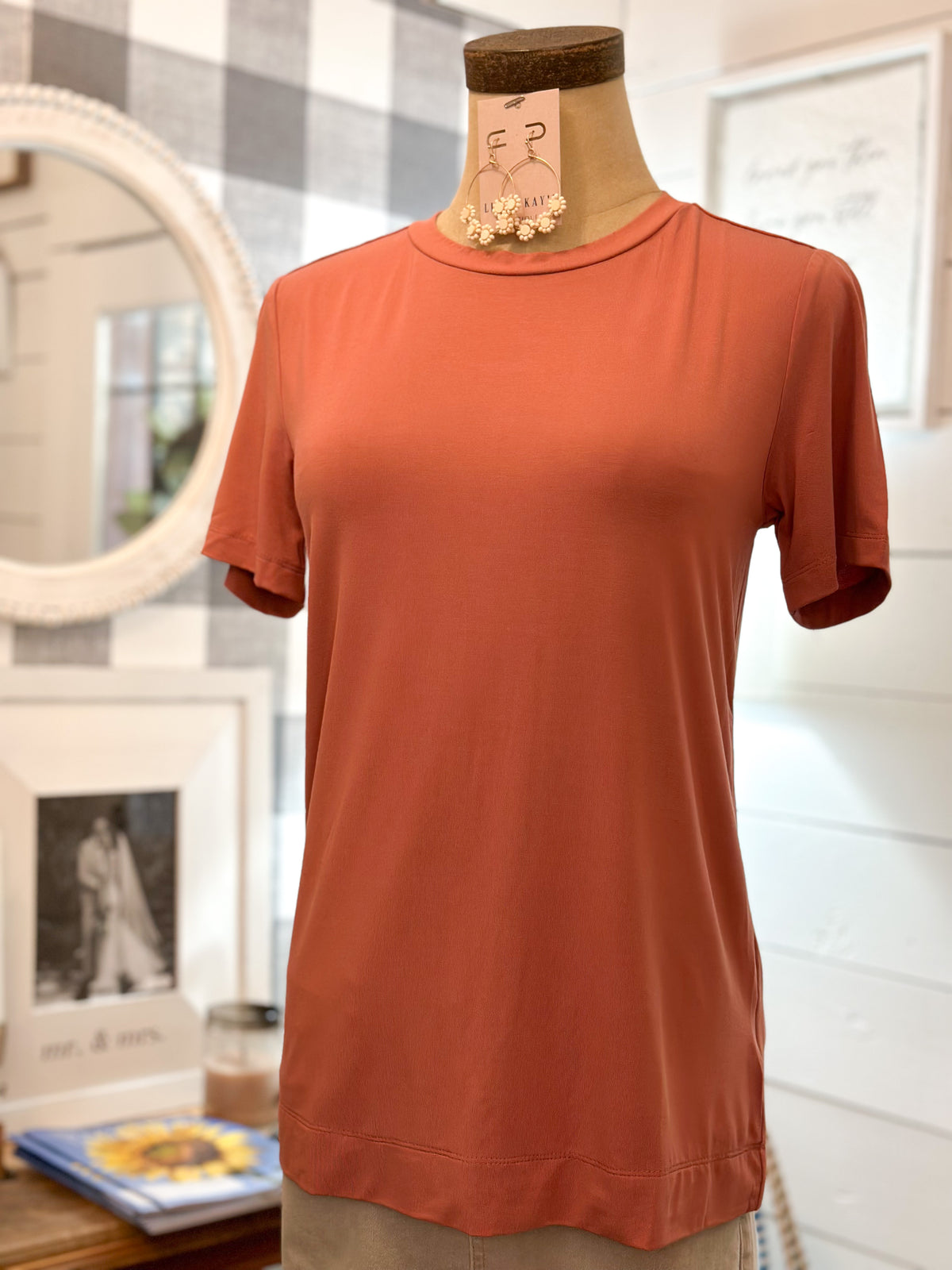 terra cotta color short sleeve top with thick hem on the bottom of top