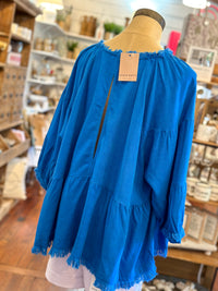 bright blue linen top with flowy sleeves and open back 