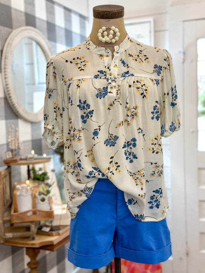cream color button short sleeve puff top with floral design