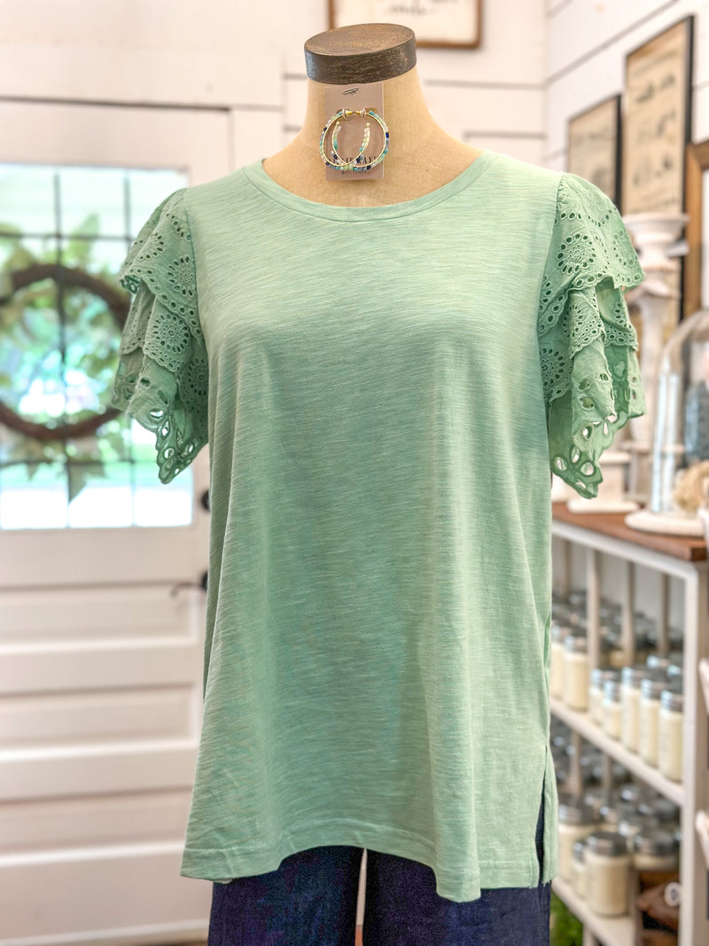 light green top with eyelet lace details on sleeves