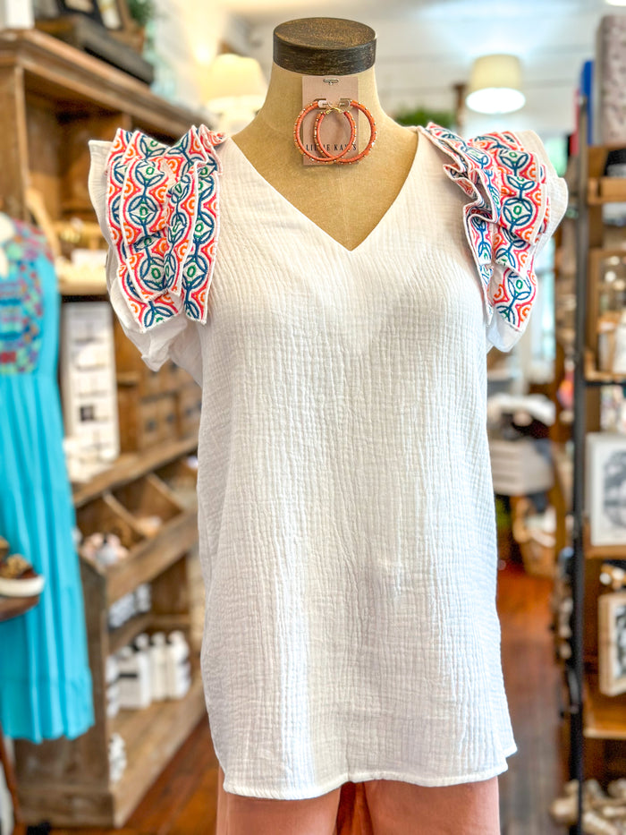 white washco top with multi color ruffle detail sleeves