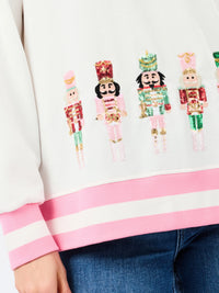 up close sequin nutcracker holiday sweater white with pink 