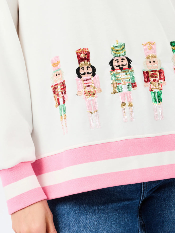 up close sequin nutcracker holiday sweater white with pink 