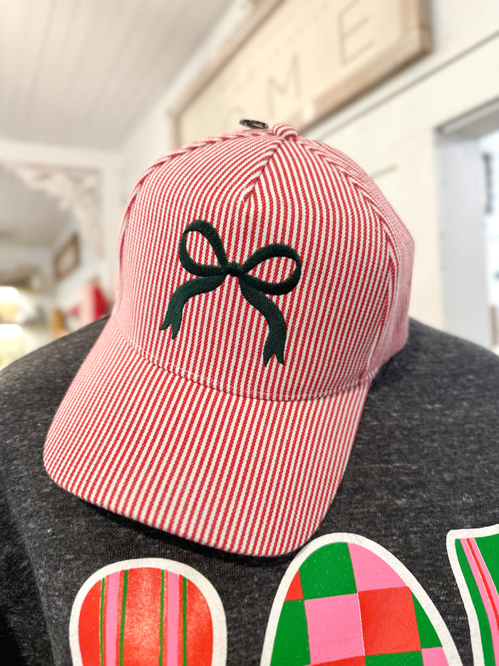 red stripe hat with green bow on the front 