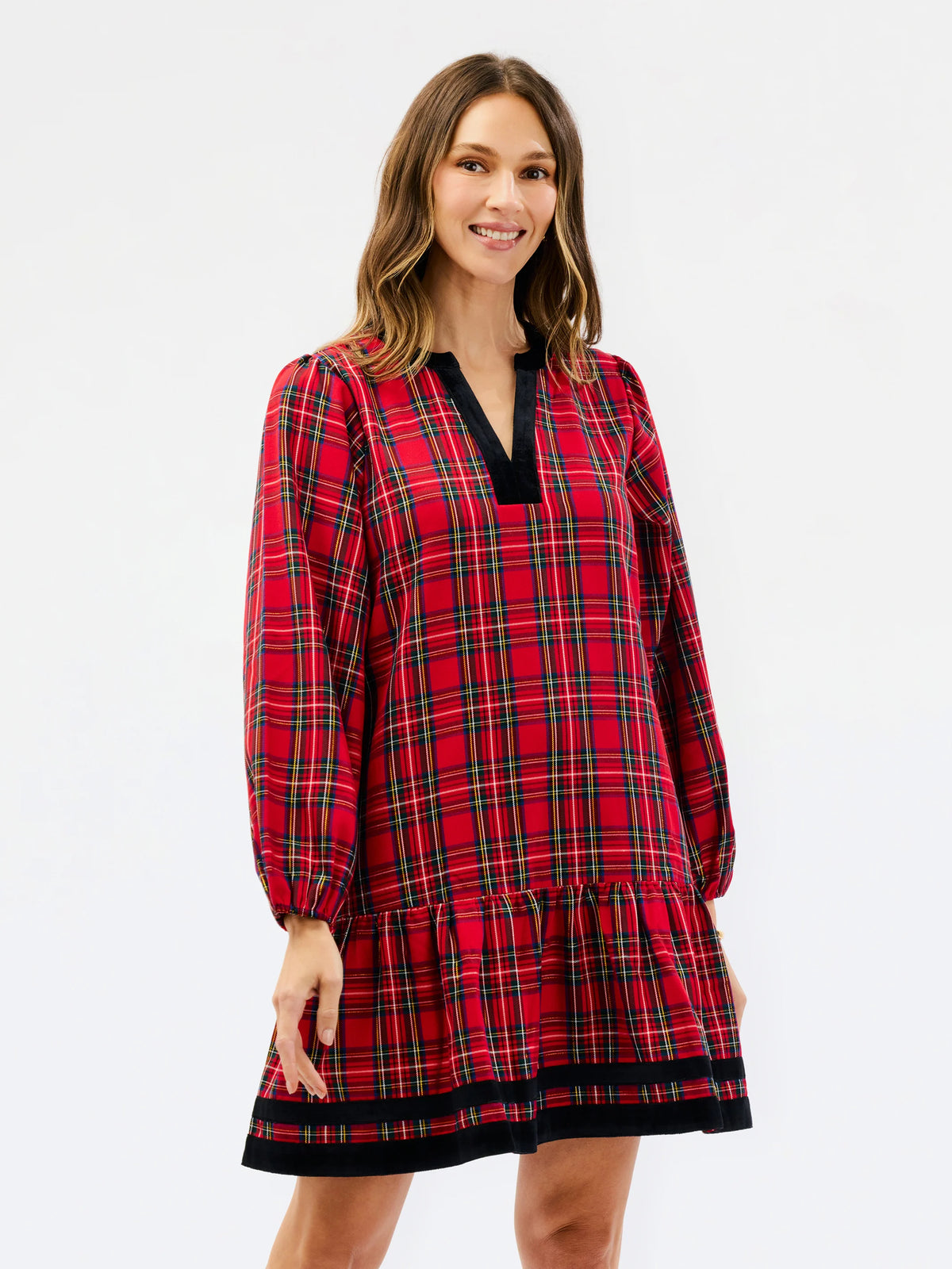 traditional red holiday plaid dress with tiered bottom and velvet details on white background 