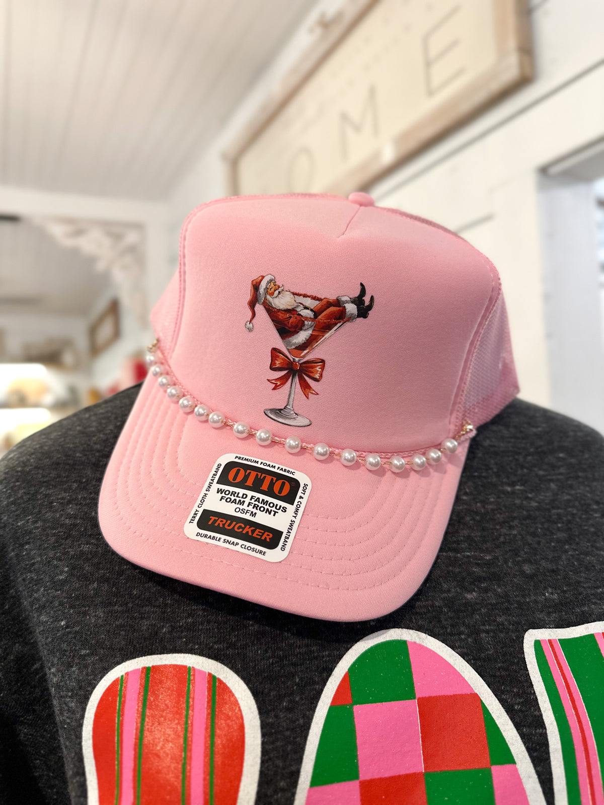 pink trucker foam hat with santa in glass with pearl chain 
