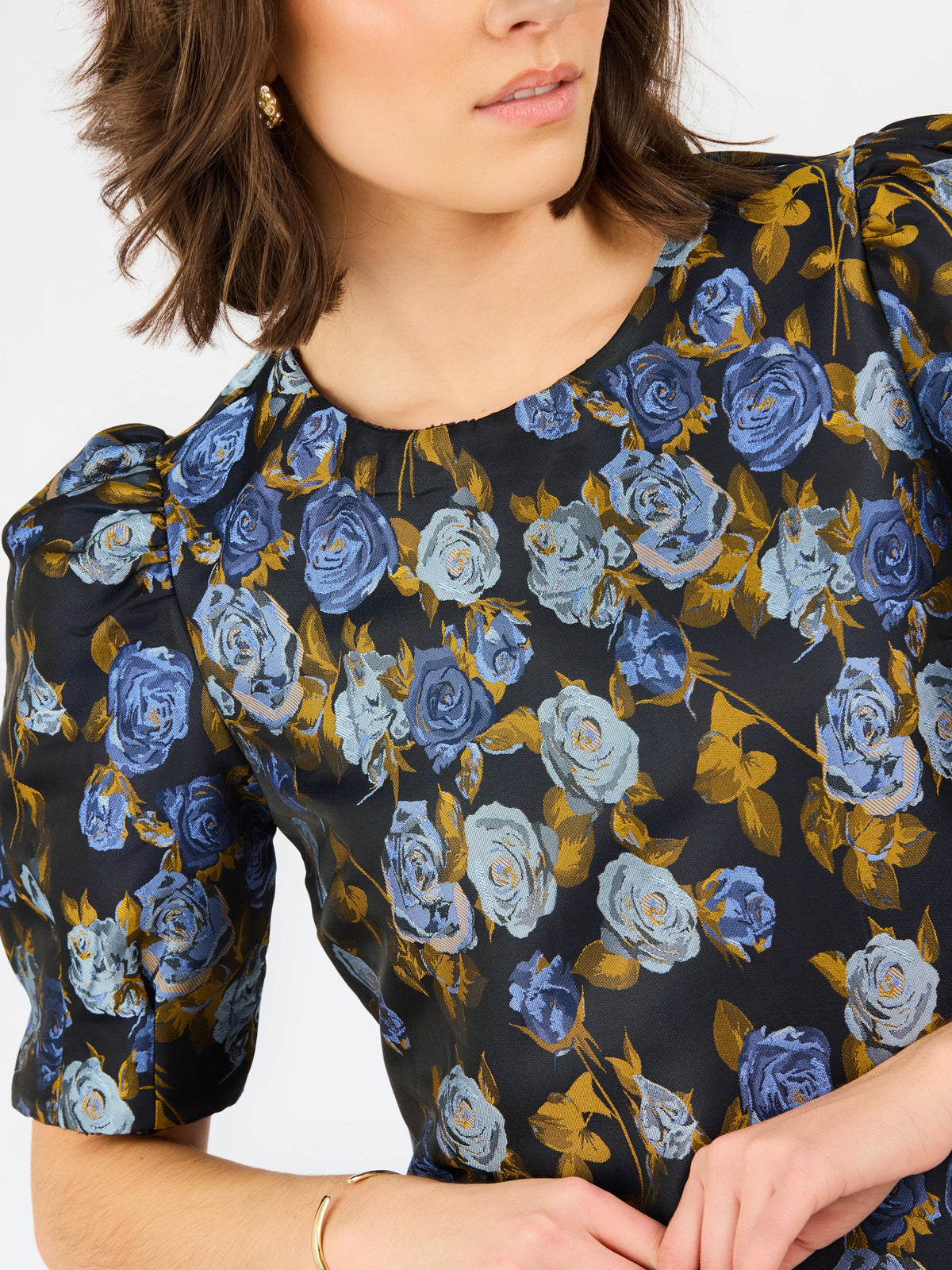 upclose blue navy brocade thea dress with white background 
