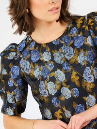 upclose blue navy brocade thea dress with white background 
