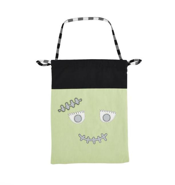 Green bag with a face design on a white background mud pie treat bag 