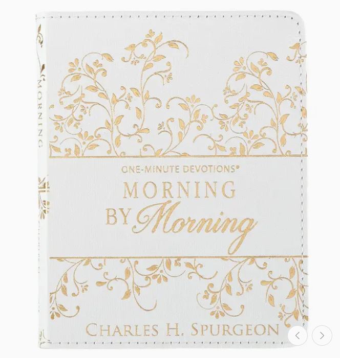 White book with gold floral patterns and text on a white background