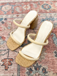 thin strap heel with rattan accents around bottom of shoe