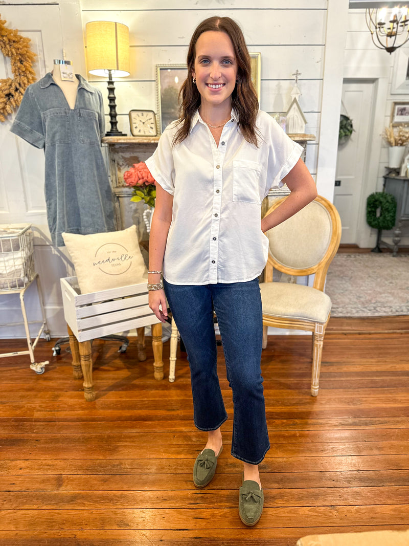white short sleeve button down top with short sleeves
and dark wash jeans