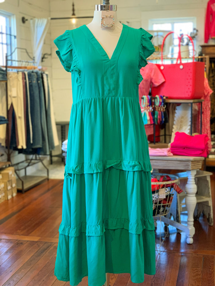 green midi dress with ruffle sleeves and ruffles on the body of the dress
