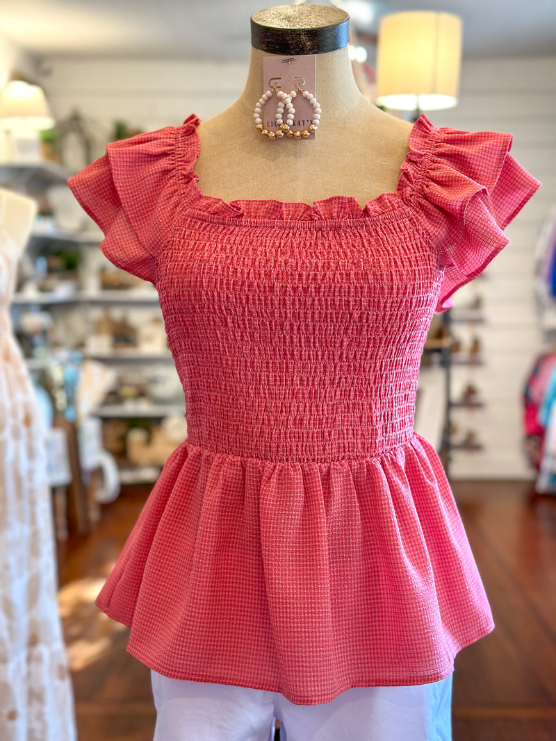 pink smocked top with ruffle sleeves