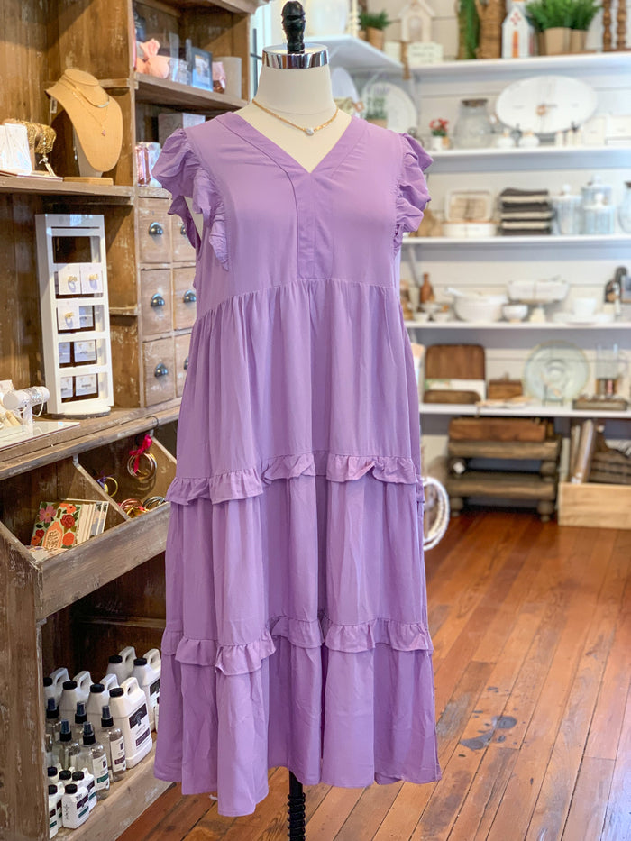lavender purple midi dress with ruffle sleeves and ruffles on the body of the dress